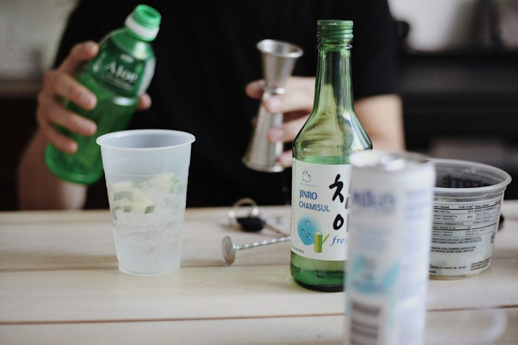 Preparing drink with soju and aloe