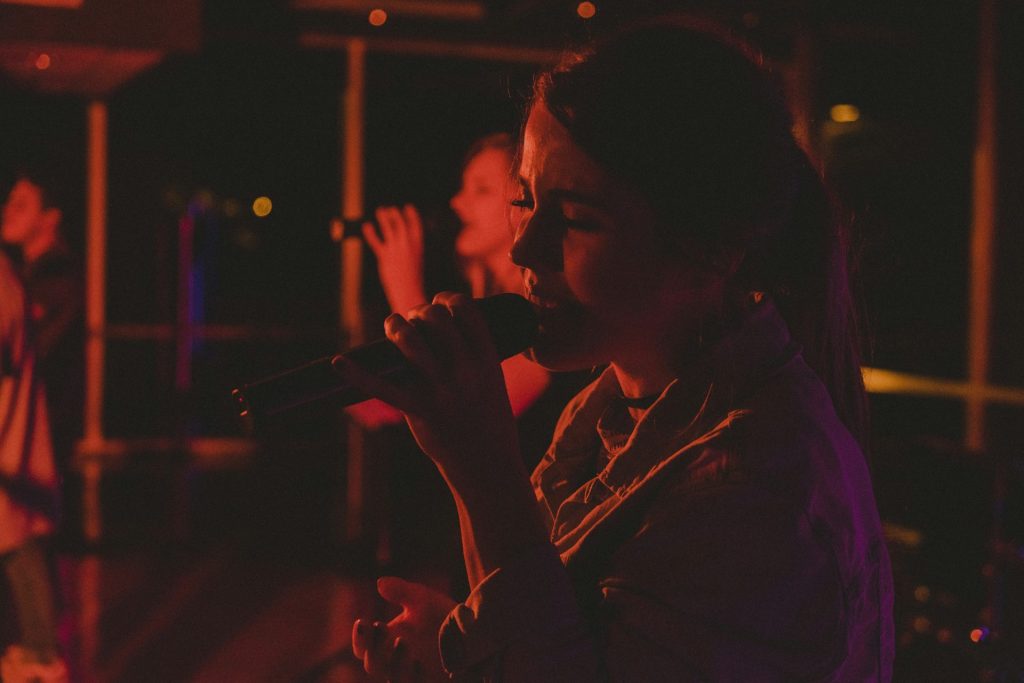 two women singing inside room